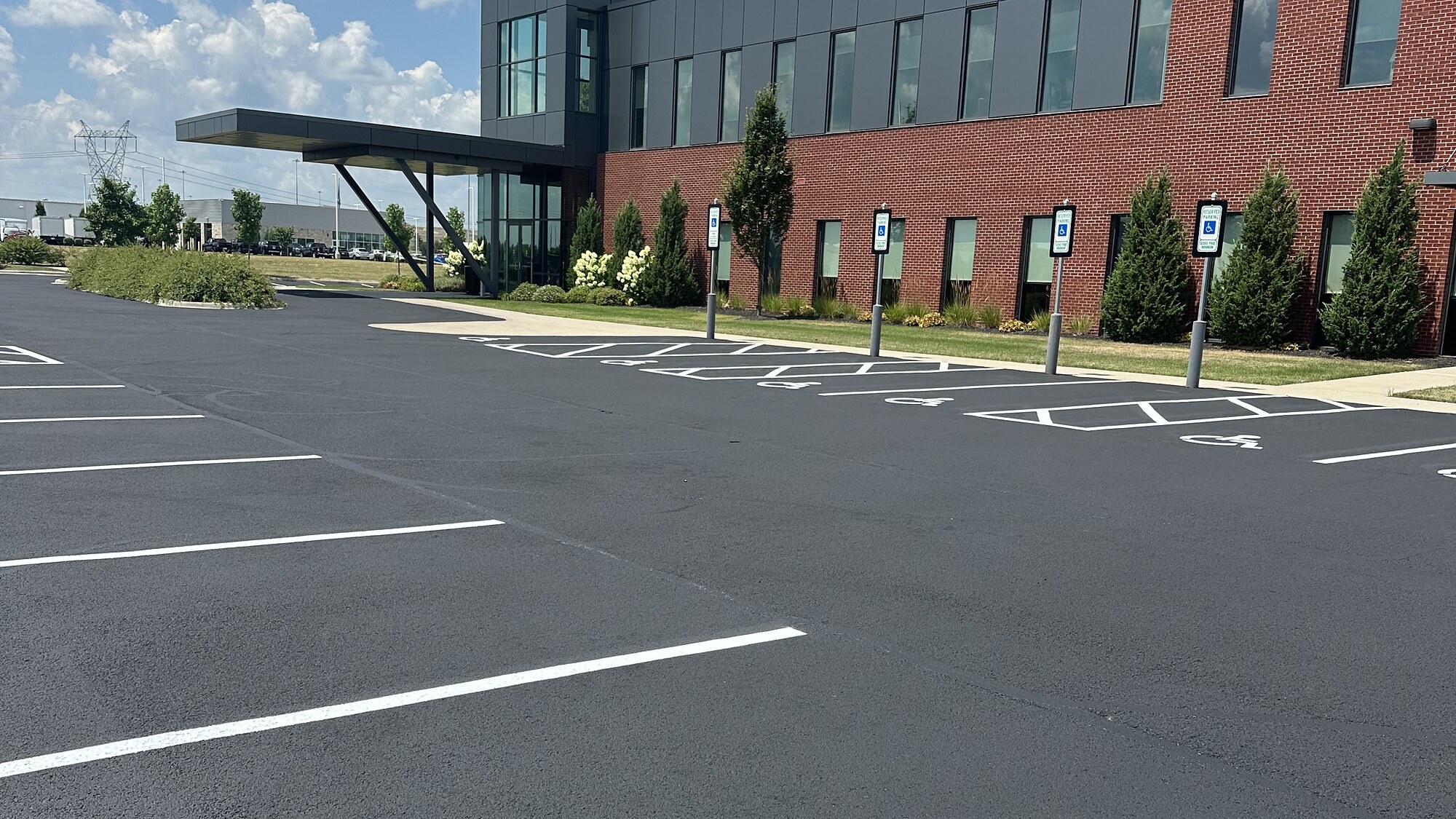 Freshly sealcoated parking lot with crisp white striping at Grove City VA Clinic