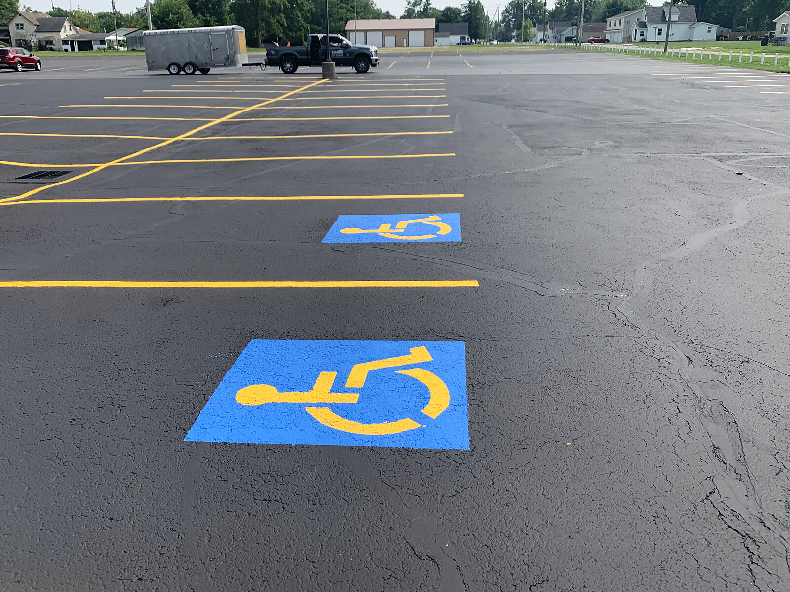 Bright blue ADA accessibility stalls with yellow striping